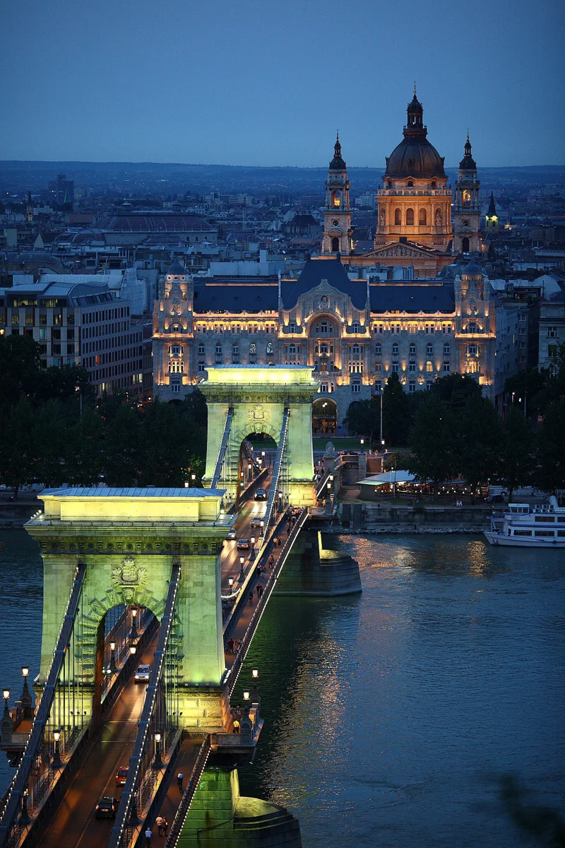 The Chain Bridge lit at dusk over the Danube, passed on a Budapest Christmas dinner cruise
