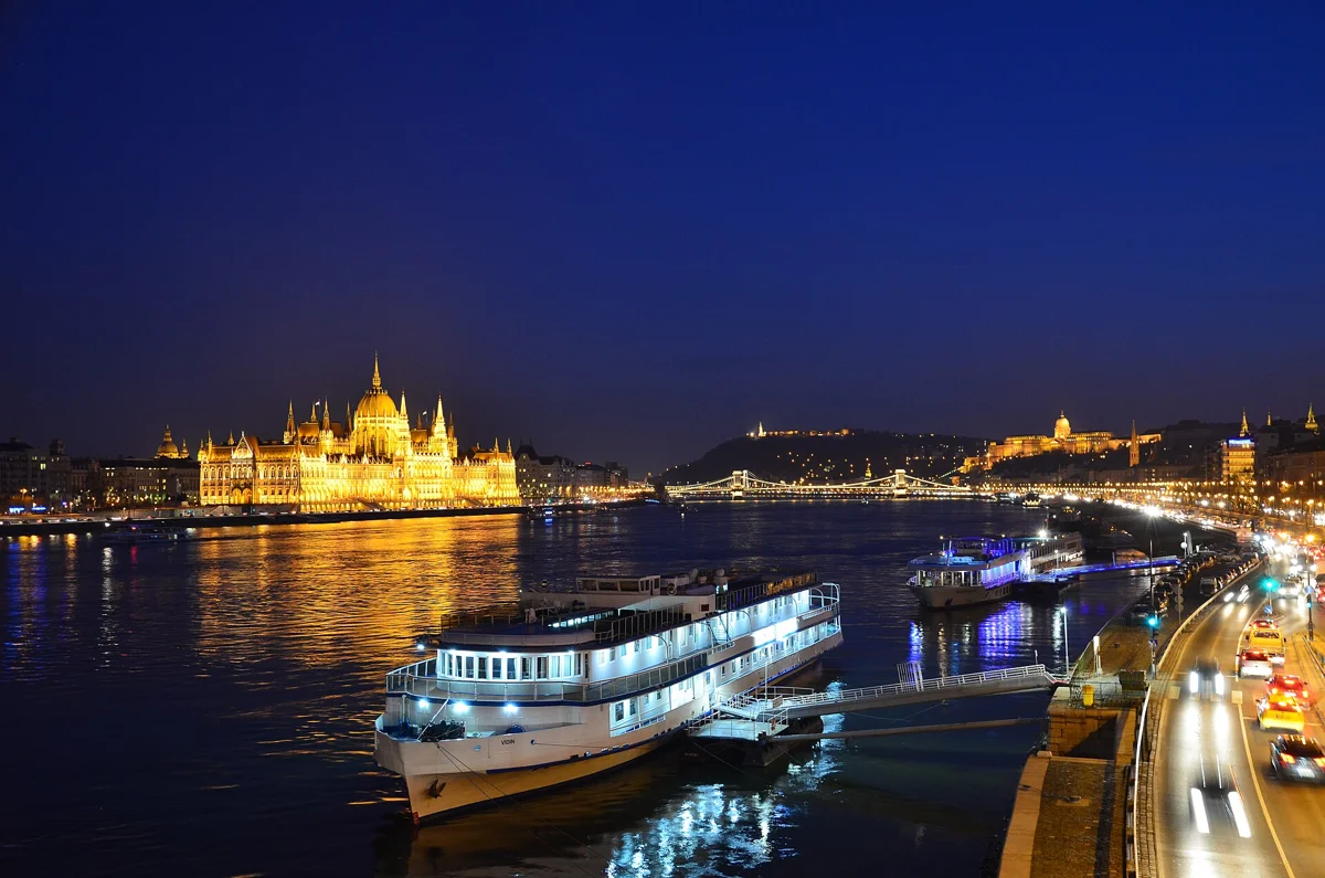 A sightseeing boat on the Danube below the lit Parliament, the view from a Budapest mulled wine cruise