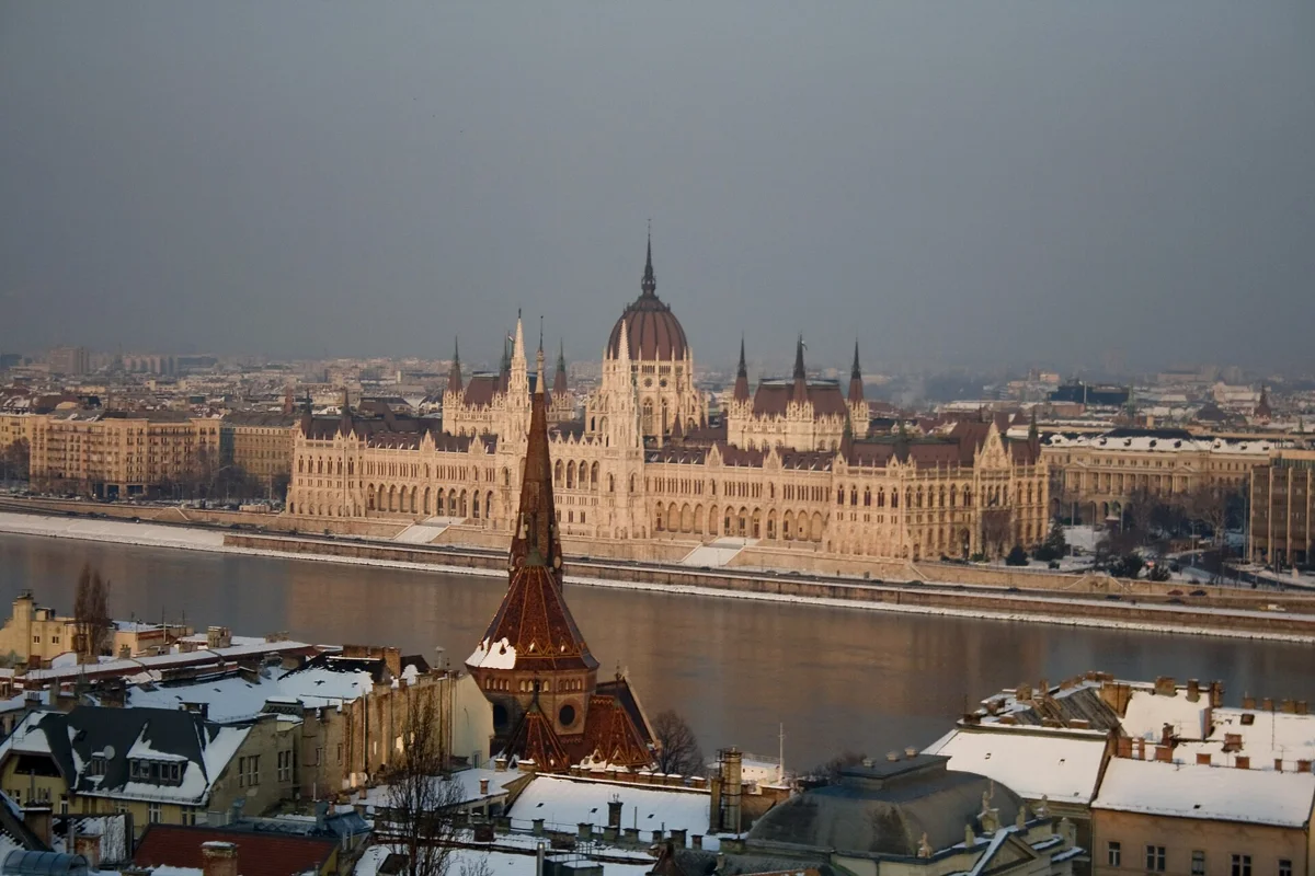 The Parliament seen across the Danube from snowy roofs, Budapest in December